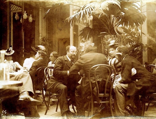 Groupe de quatre personnes attablées à une terrasse de café, dont Bernard Lazare et sa femme